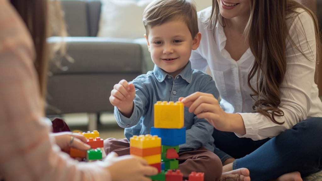 A smiling young boy engaging in a play therapy session with a counselor, building a structure with colorful blocks in a warm, well-lit office.